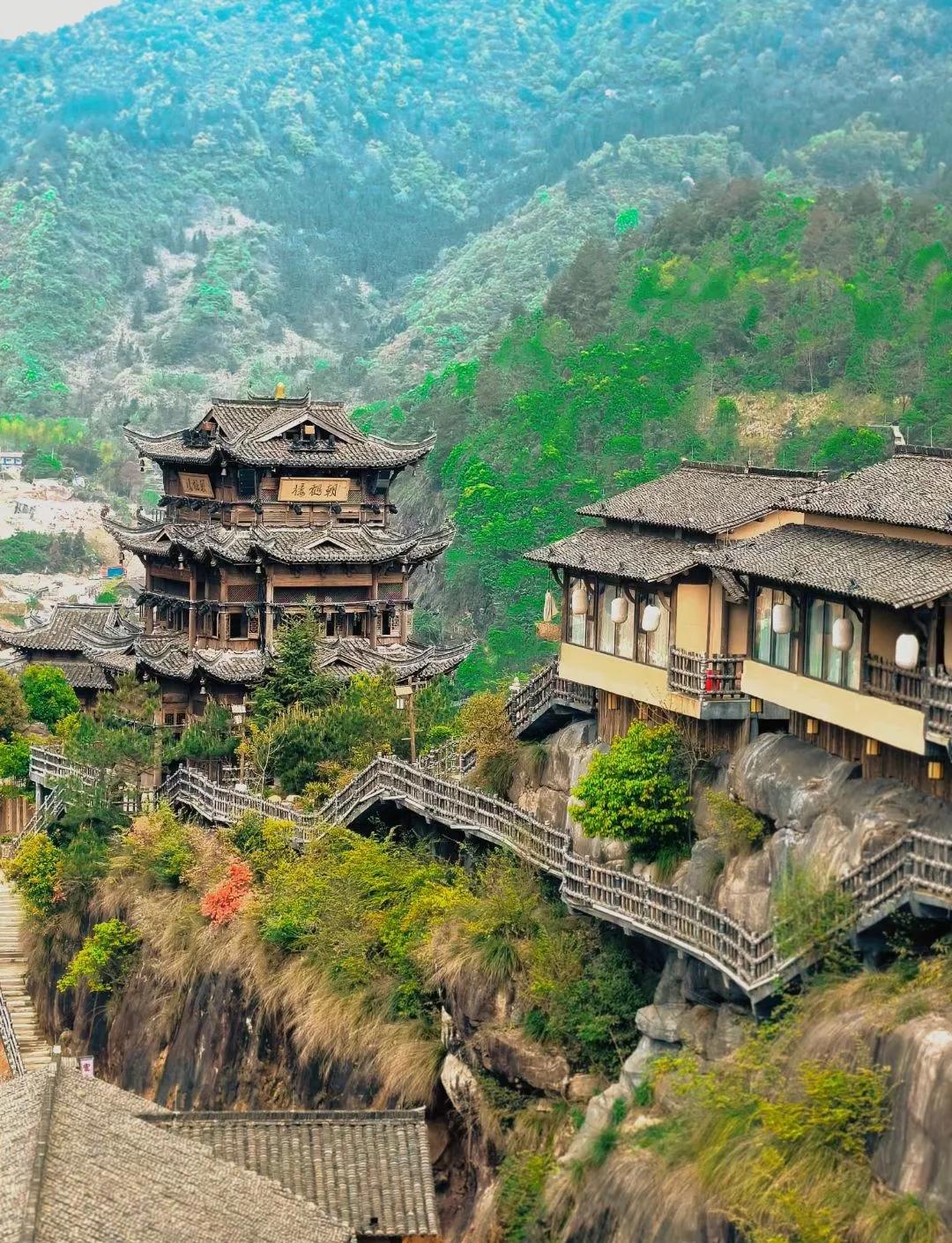 Wangxian Valley cliff village in mist
